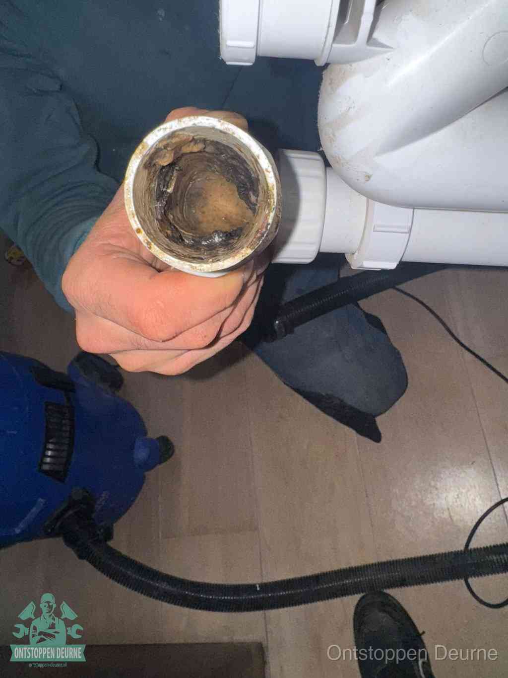 Een losgekoppeld afvoerbuisstuk dat van binnen volledig is dichtgeslibd, het gevolg van een verstopping te lang laten zitten in Deurne